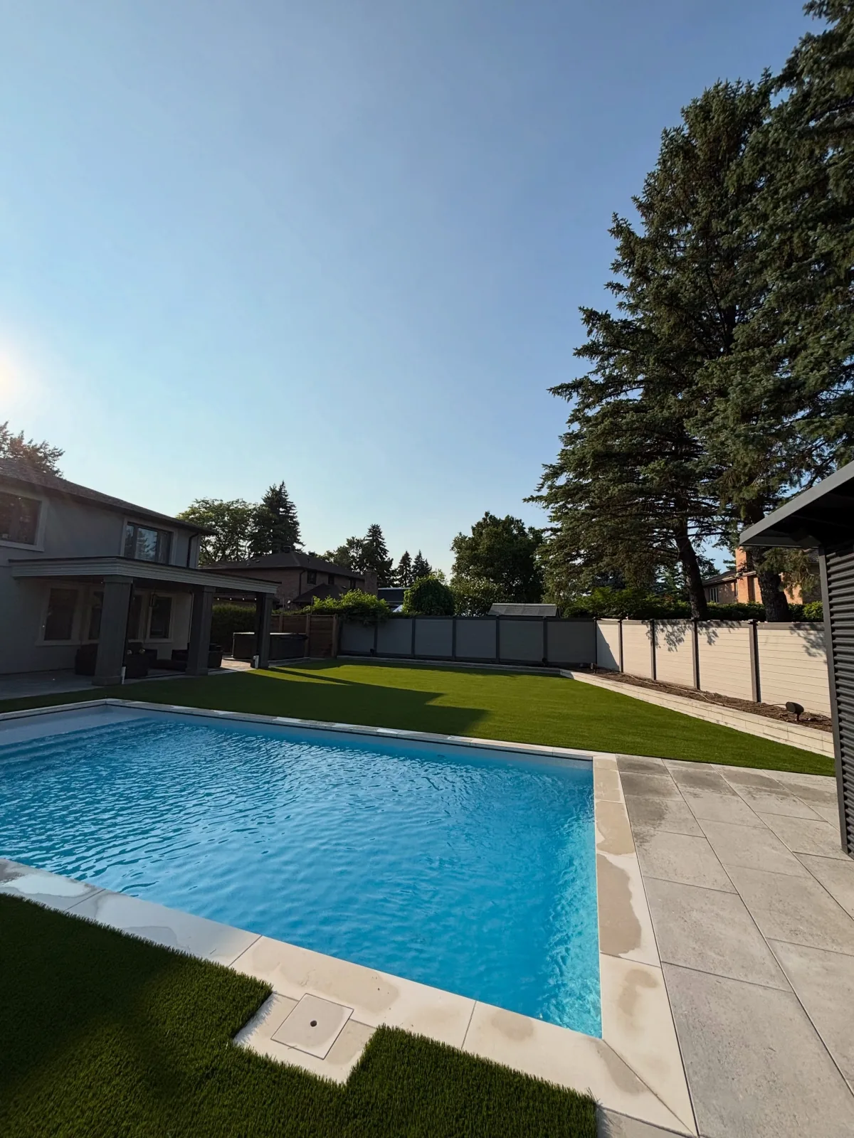 Artificial grass installed around a backyard pool in Mississauga